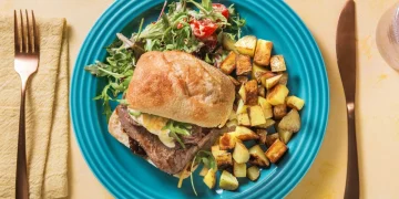 Steak Sandwich and Fried Potatoes with a Mustardy Rocket and Tomato Salad